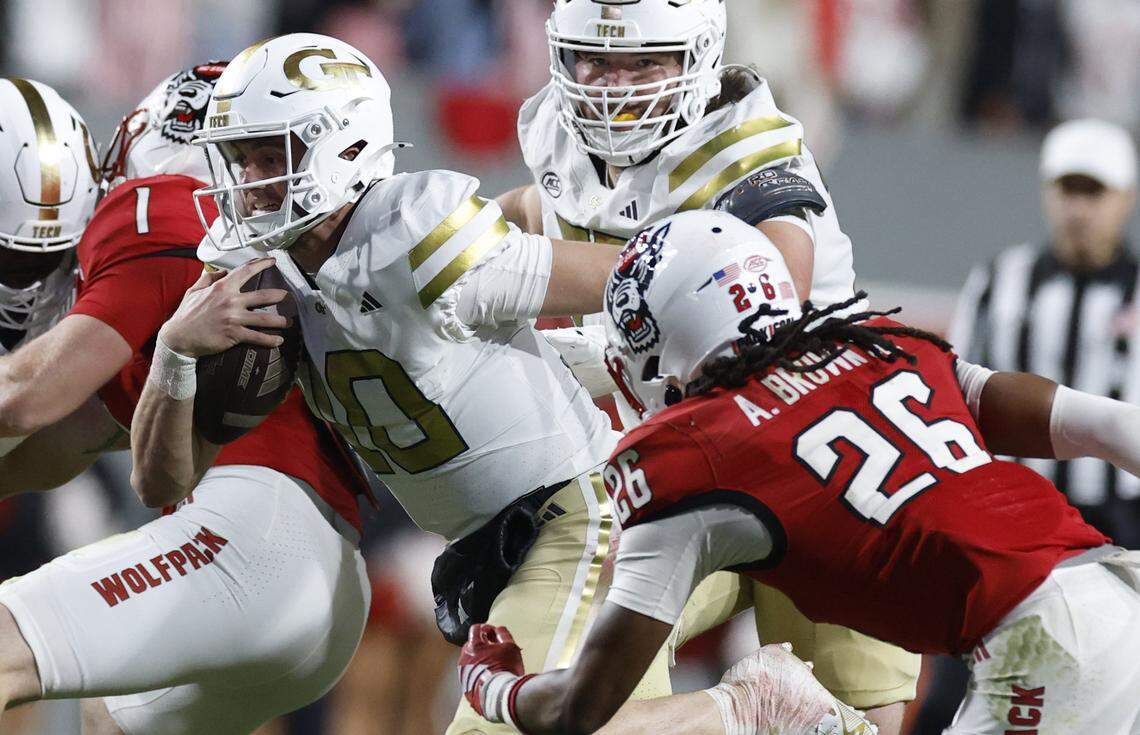 Georgia Tech quarterback Haynes King (10) runs for yards as N.C. State defensive back Asaad Brown Jr. (26) follows during the first half of N.C. StateÕs game against Georgia Tech at Carter-Finley Stadium in Raleigh, N.C., Saturday, Nov. 1, 2025.