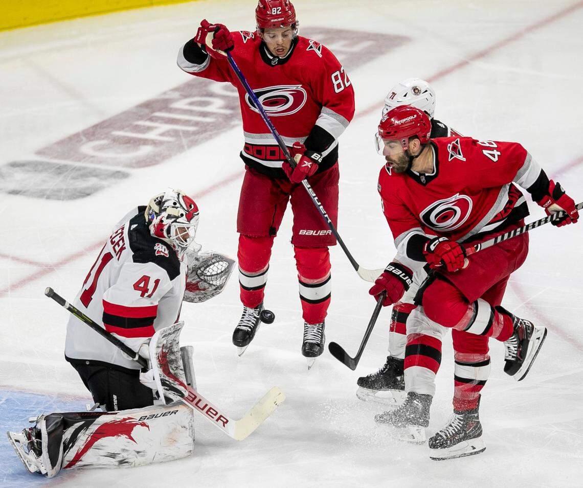 The Carolina Hurricanes Jordan Martinook (48) and Jesperi Kotkaniemi (82) position themselves for a rebound after a deflection by New Jersey Devils goalie Vivek Vanecek (41) during the third period in Game 2 of their second round Stanley Cup playoff series on Friday, May 5, 2023 at PNC Arena in Raleigh, N.C.