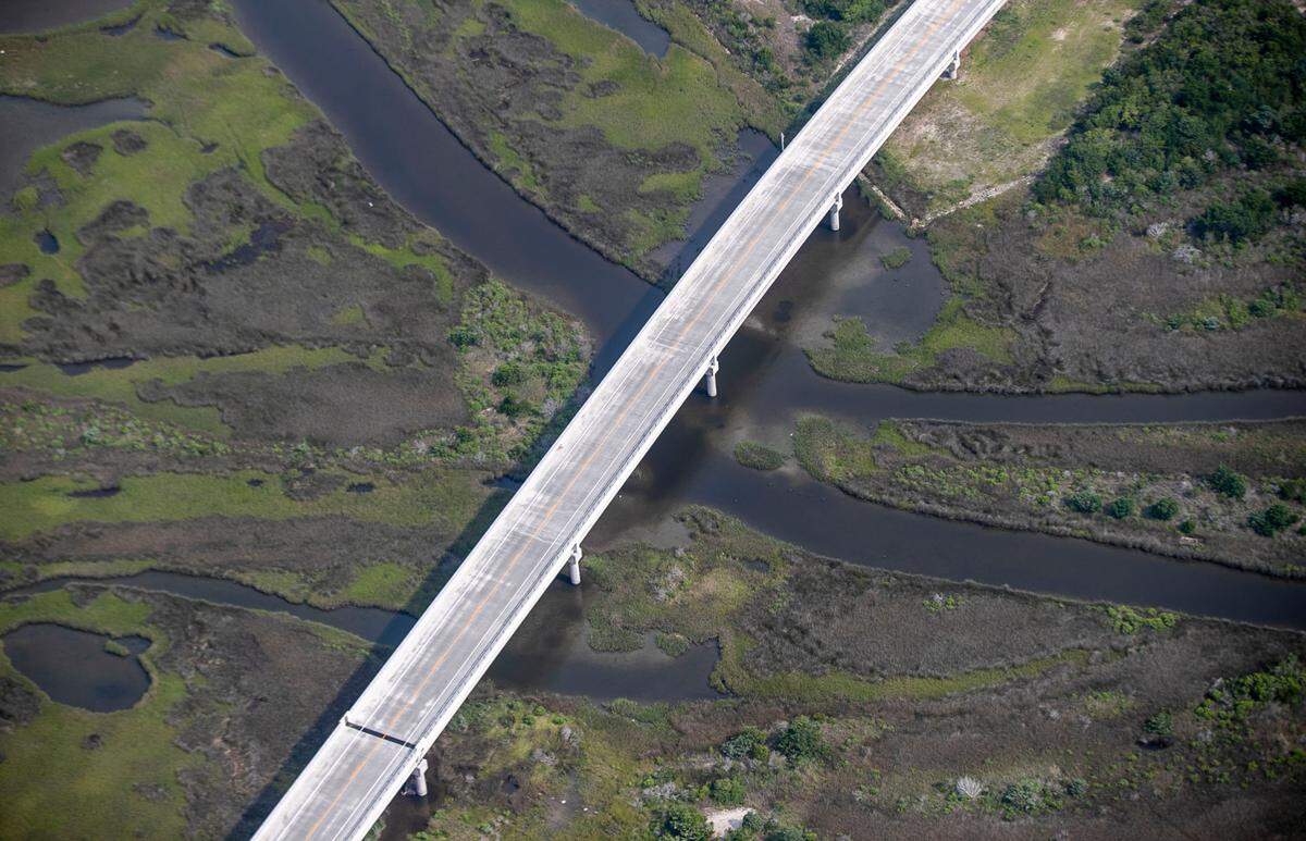 A segment NC 12, the Marc Basnight Bridge, dissects salt marsh as it crosses the Oregon Inlet offering residents and visitors access to Hatteras Island on Wednesday, July 21, 2021. The Basnight Bridge opened in 2019 and replaced the Herbert Bonner Bridge that opened in 1963.