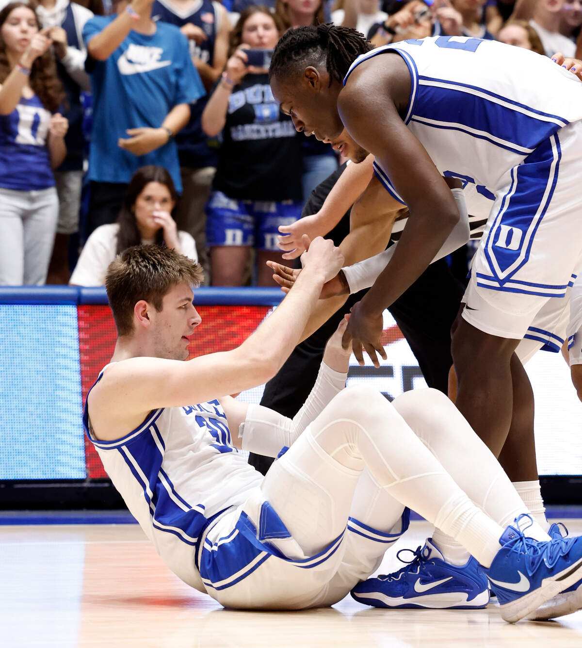 Duke’s Mark Mitchell (25) and Jared McCain (0) help up Kyle Filipowski (30) after he was fouled during the second half of Duke’s 90-60 victory over Bucknell at Cameron Indoor Stadium in Durham, N.C., Friday, Nov. 17, 2023.