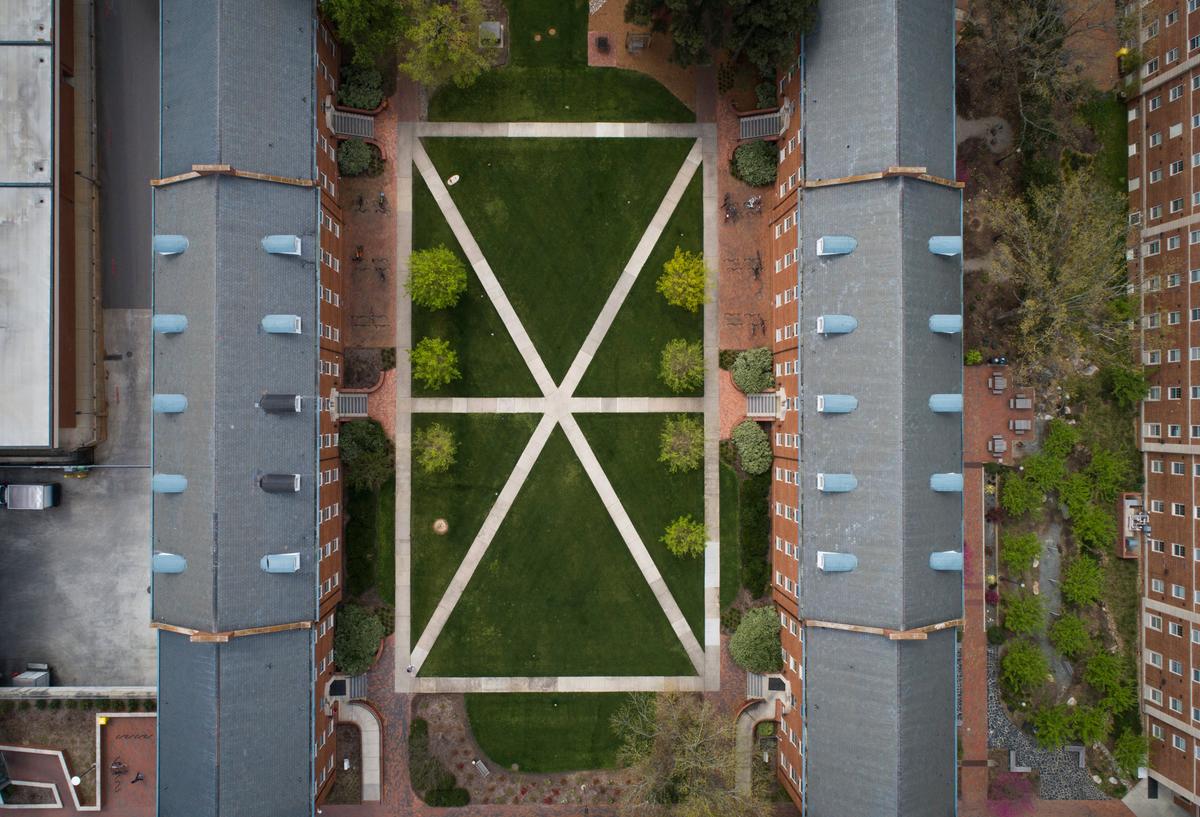 Only a few people could be seen walking between Turlington Residence Hall, right, and Alexander Residence Hall, left, on N.C. State’s campus on Friday, March 27, 2020.