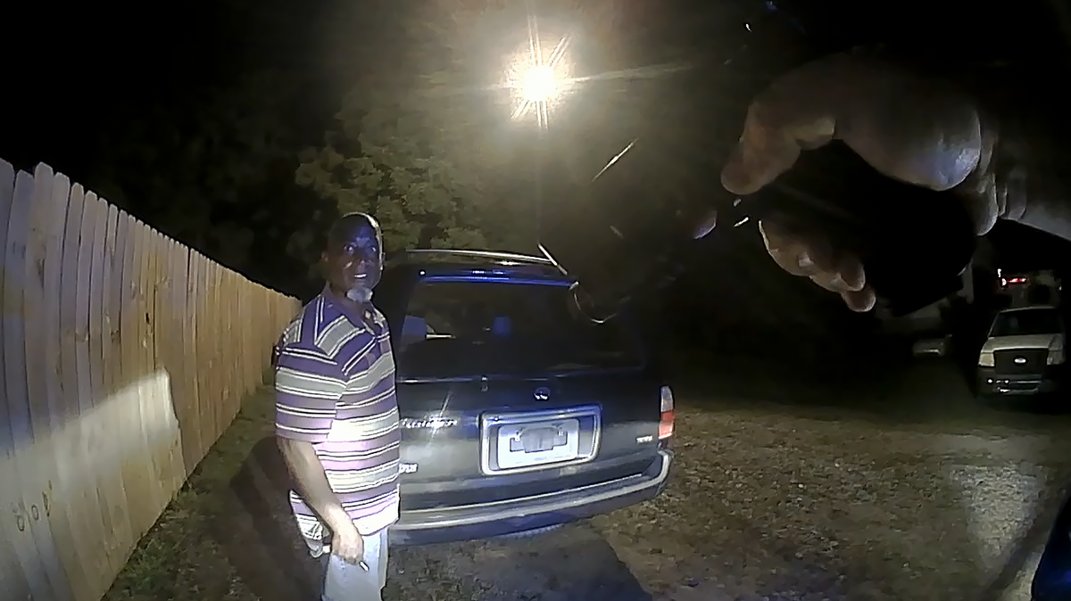 In an image taken from body camera footage released by the Warrenton Police Department under court order, former officer Mark Oakley approaches Dwayne Hicks during a second stop September 2023, this time with his weapon drawn.