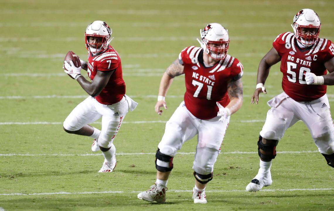 N.C. State running back Zonovan Knight (7) heads upfield with blocking by guard Joe Sculthorpe (71) and center Grant Gibson (50) during the second half of N.C. State’s 45-42 victory over Wake Forest at Carter-Finley Stadium in Raleigh, N.C, Saturday, Sept. 19, 2020.