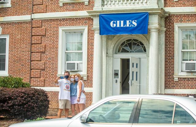 From left, David, Maggie, and Valerie Love pause for a photo in between trips to the car while moving Maggie into her dorm room in Giles Residence Hall for her first year at Duke University, on Friday, Aug. 7, 2020, in Durham, N.C.