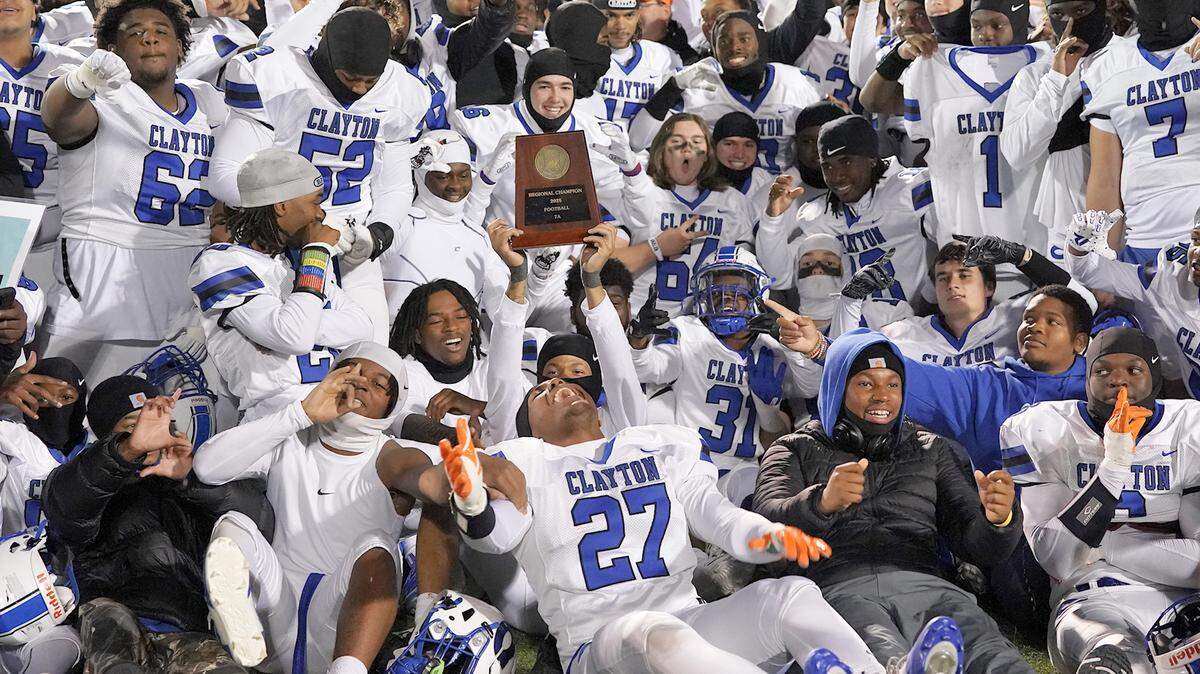 The Clayton Comets celebrate as the 2025 East Regional Final Champion after their defeat of Cardinal Gibbons. The Clayton Comets and the Cardinal Gibbons Crusaders met in the East Regional Final of the NCHSAA 7A Football Championship in Clayton, N.C. on December 4, 2025.