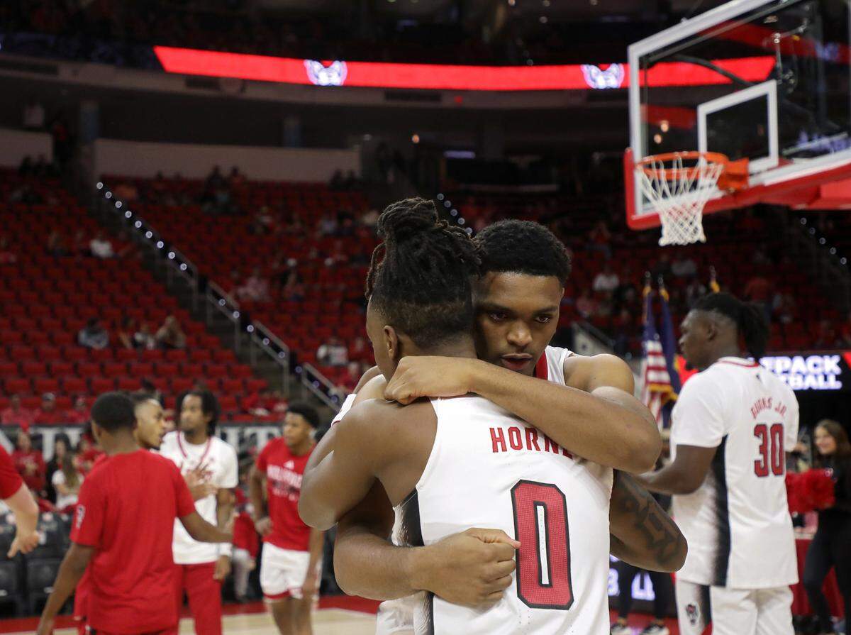 N.C. State’s Casey Morsell hugs teammate DJ Horne prior to the Wolfpack’s season-opening game against The Citadel on Monday, Nov. 6, 2023, at PNC Arena in Raleigh, N.C.