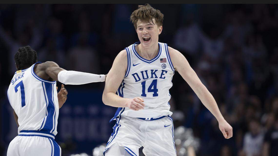 Duke guards Nikolas Khamenia (14) and Dame Sarr (7) celebrate the Blue Devils’ 74-70 victory over Virginia on Saturday, March 14, 2026, during the ACC Tournament Championship at Spectrum Center in Charlotte, N.C.