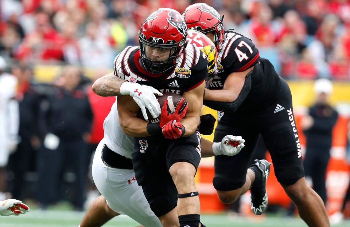 N.C. State running back Jordan Houston (3) is wrapped up by the Maryland defense during the second half of Maryland’s 16-12 victory over N.C. State in the Duke’s Mayo Bowl at Bank of America Stadium in Charlotte, N.C., Friday, Dec. 30, 2022.