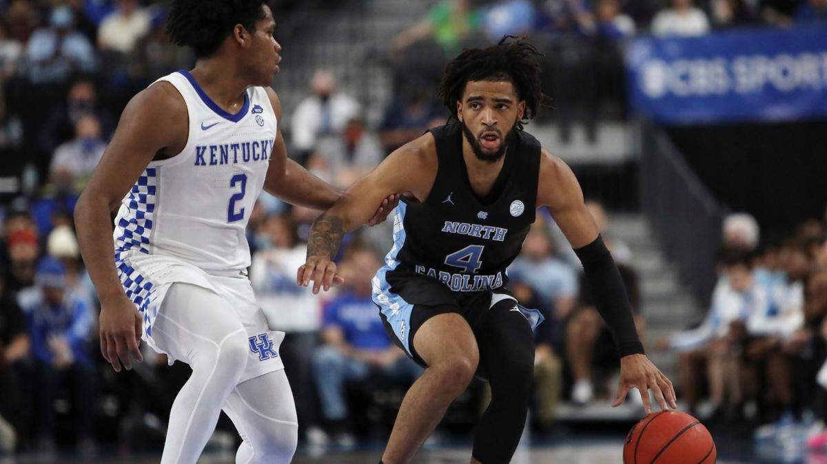 North Carolina’s R.J. Davis (4) advances the ball against Kentucky’s Sahvir Wheeler (2) during the first half of an NCAA college basketball game Saturday, Dec. 18, 2021, in Las Vegas. (AP Photo/Joe Buglewicz)