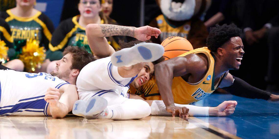 Duke’s Ryan Young (15) and Tyrese Proctor (5) dive after a loose ball with Vermont’s Sam Alamutu (2) during the second half of Duke’s 64-47 victory over Vermont in the first round of the NCAA Tournament at the Barclays Center in Brooklyn, N.Y., Friday, March 22, 2024.