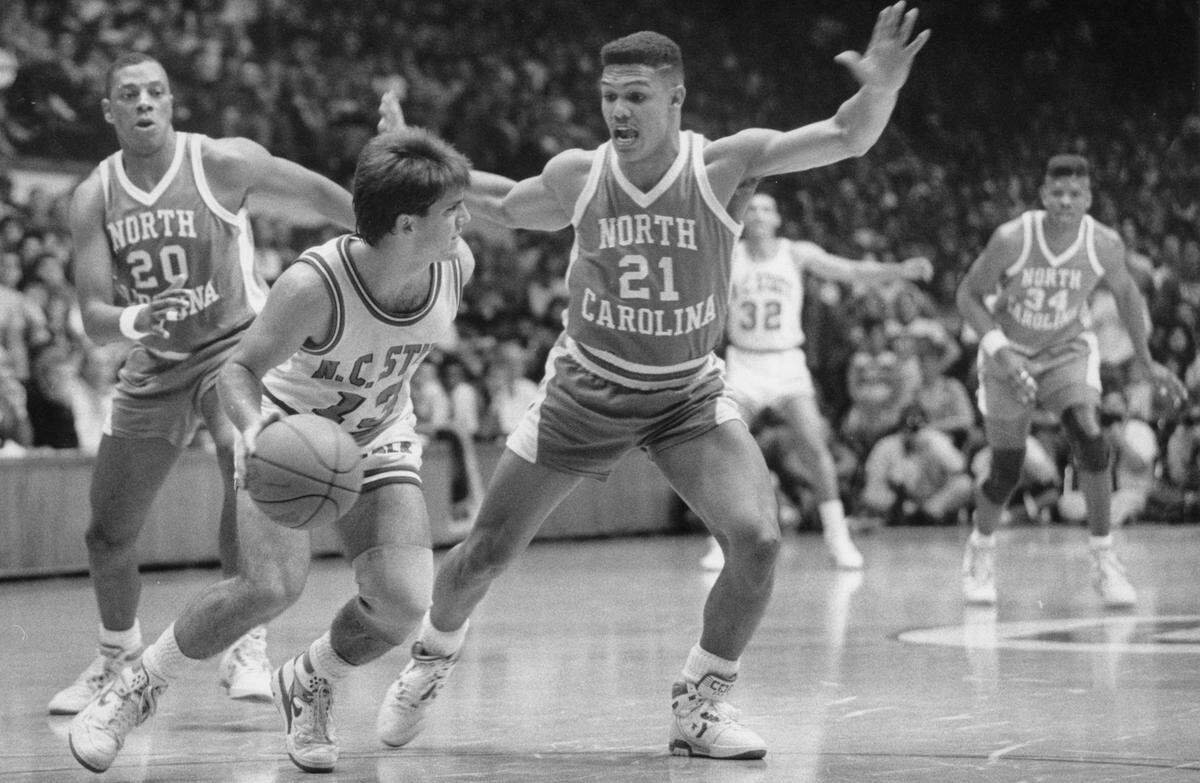 UNC’s King Rice (21), right, get tough against NC State’s Chhris Corchiani, as he takes the ball up the court during a 1989 game.