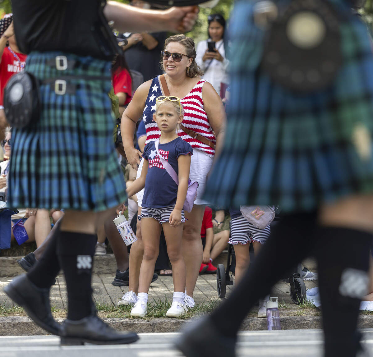 Parade attendees watch the Wake & District Pipe Band as they march along Salisbury Street in front of the State Capitol, during the First in Freedom Parade on Saturday, July 4, 2026 in Raleigh, N.C.
