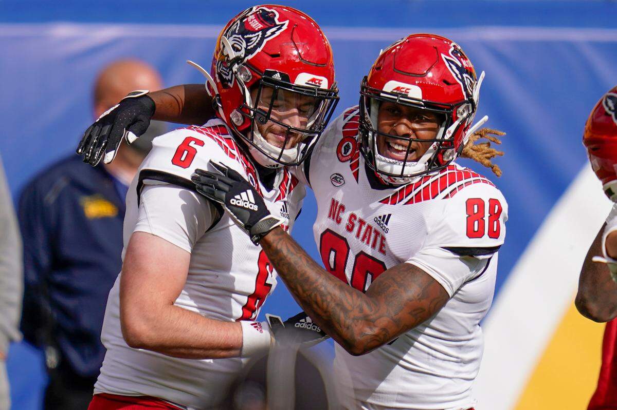 North Carolina State tight end Cary Angeline (6) celebrates with wide receiver Devin Carter (88) after making a touchdown catch against Pittsburgh during the second half of an NCAA college football game, Saturday, Oct. 3, 2020, in Pittsburgh. North Carolina State won 30-29.