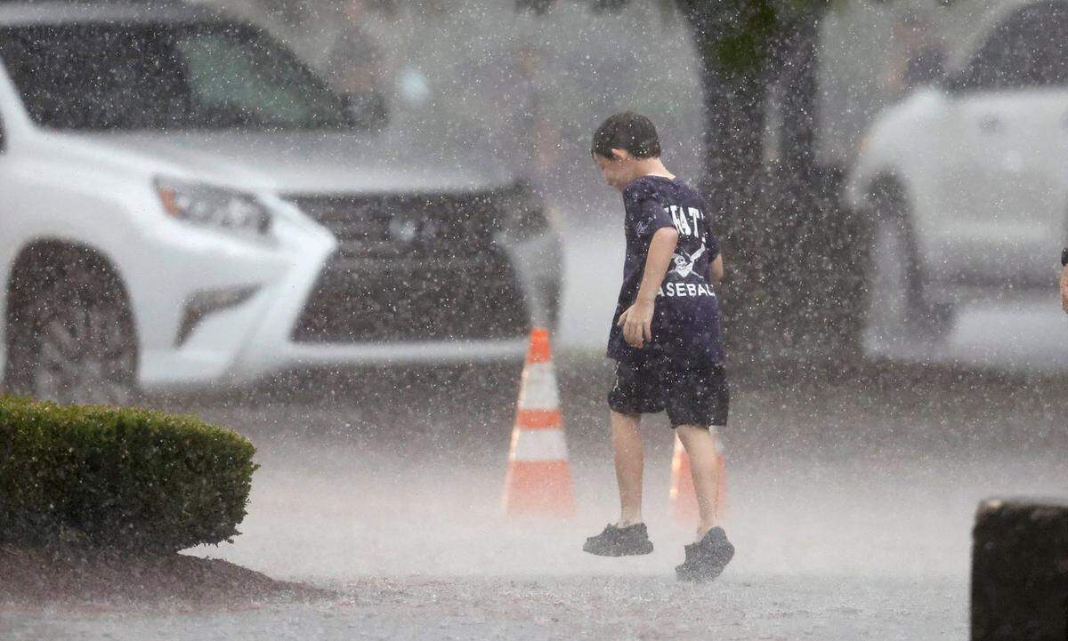A fan walks outside the stadium during a weather delay in the first inning during ECUs game against Texas in the Greenville Super Regional at Clark-LeClair Stadium Sunday, June 12, 2022.