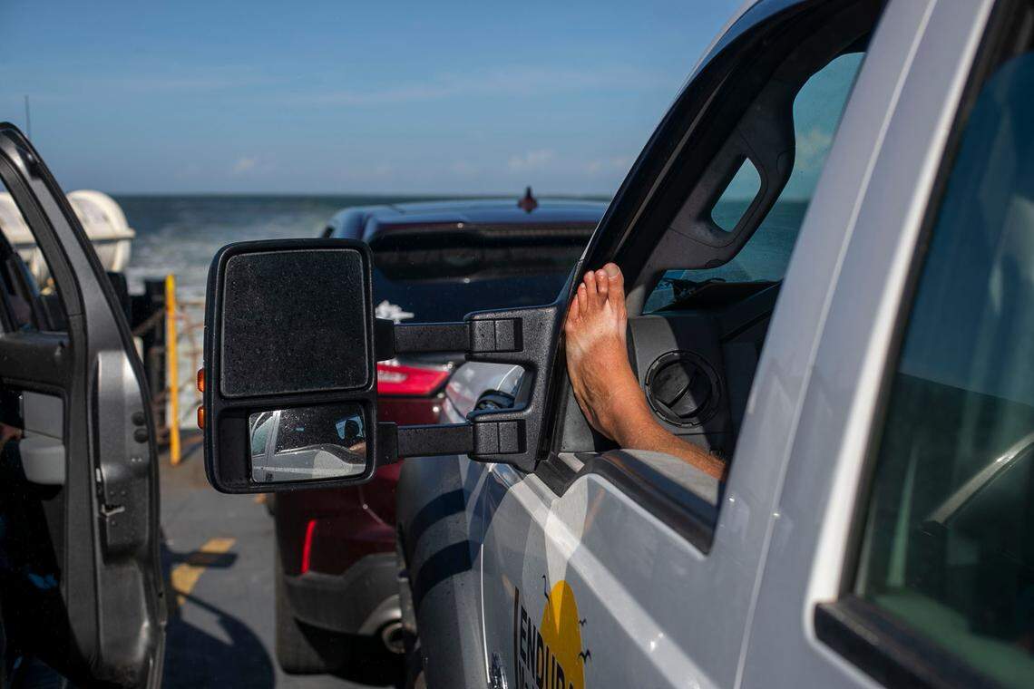 A passenger aboard the Cape Point Ferry shows their tan lines from a pair of flip flops during the trip from Hatteras to Ocracoke on Thursday, July 1, 2021.