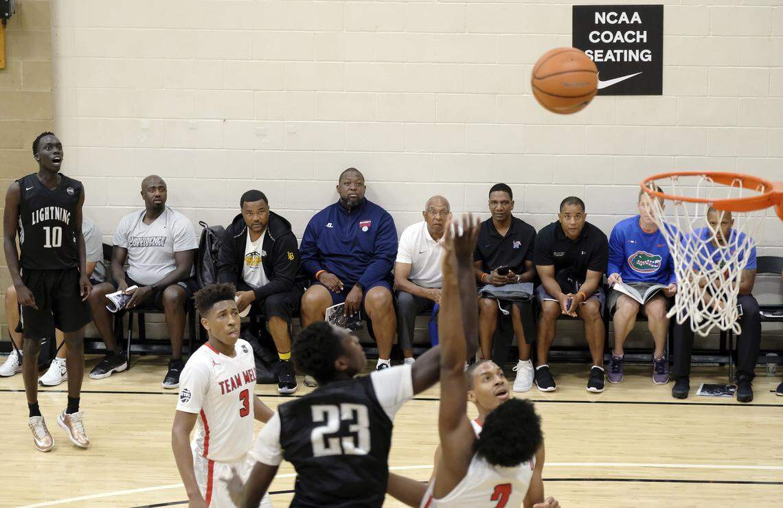 Basketball coaches watch a game during the opening night of the Nike Peach Jam at Riverview Park in North Augusta, S.C., Wednesday, July 12, 2017. (AP Photo/Todd Bennett)