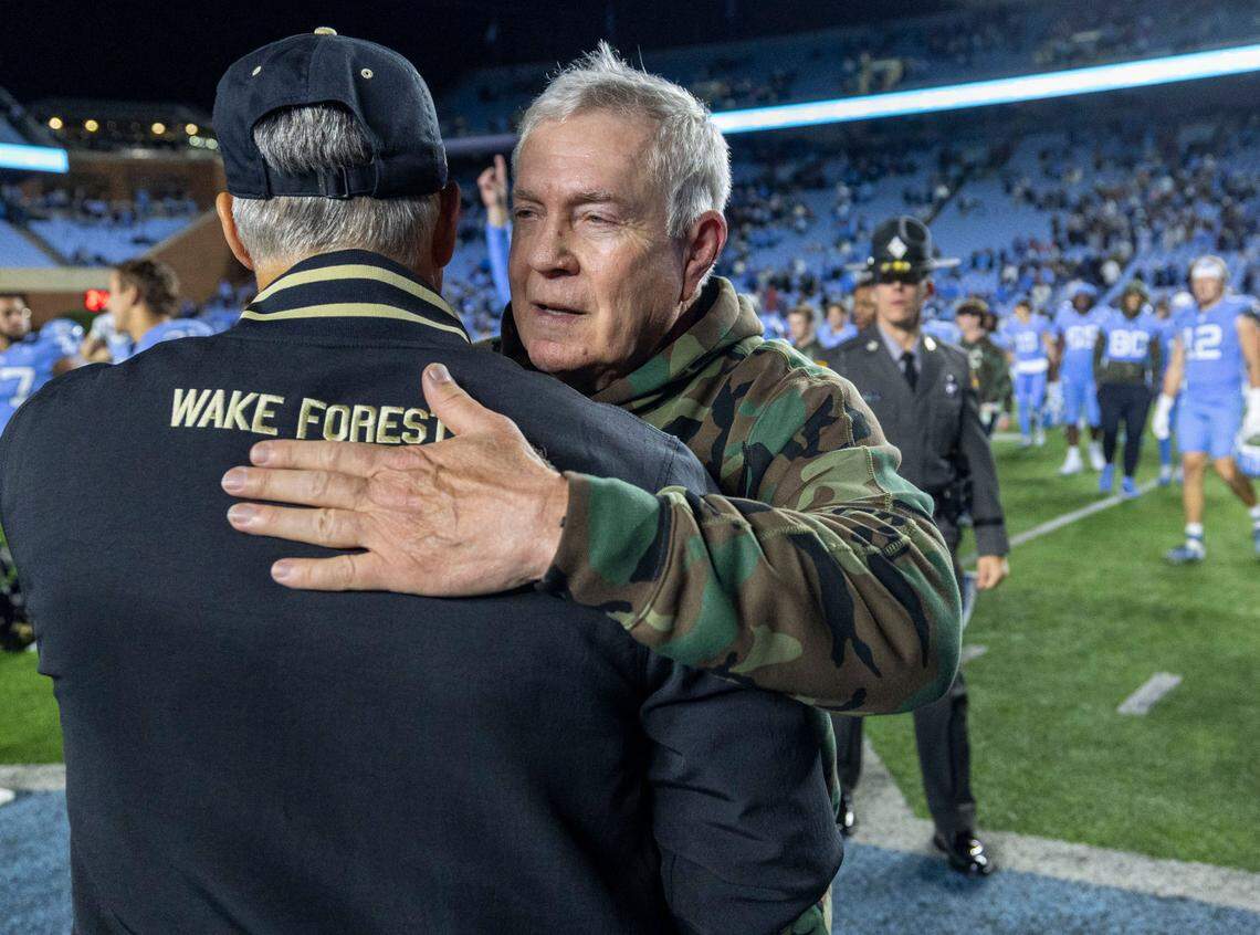 North Carolina coach Mack Brown embraces Wake Forest coach Dave Clawson following the Tar Heels’ 31-24 victory on Saturday, November 16, 2024 at Kenan Stadium in Chapel Hill, N.C.