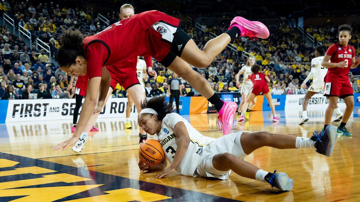 Khamil Pierre, top. of the N.C. State Wolfpack goes over Mila Holloway (3) of the Michigan Wolverines during the teams’ NCAA Women's Basketball Tournament Round of 32 game at Crisler Arena on March 22, 2026 in Ann Arbor, Michigan.
