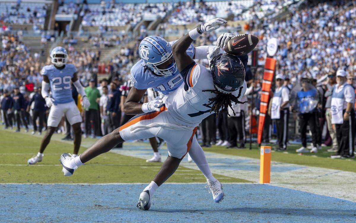 North Carolina defensive back Jaiden Patterson (18) breaks up a pass intended for Virginia wide receiver Jamal Edrine (7) in overtime on Saturday, October 25, 2025 at Kenan Stadium in Chapel Hill, N.C.