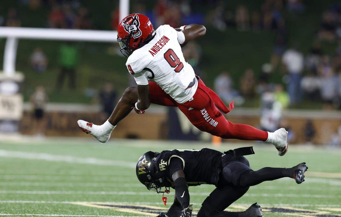 N.C. State wide receiver Terrell Anderson (9) hurdles over Wake Forest defensive back Zamari Stevenson (17) during the second half of N.C. State’s 34-24 victory over Wake Forest at Allegacy Stadium in Winston-Salem, N.C., Thursday, Sept. 11, 2025.