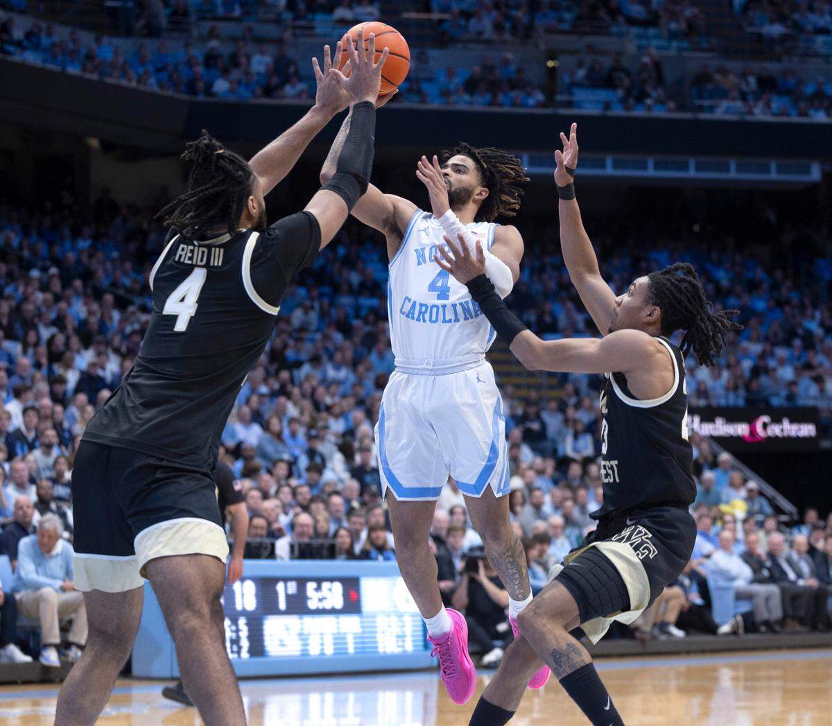 Wake Forest’s Efton Reid III (4) and Hunter Sallis (23) defends North Carolina’s R.J. Davis (4) during the first half on Monday, January 22, 2024 at the Smith Center in Chapel Hill, N.C