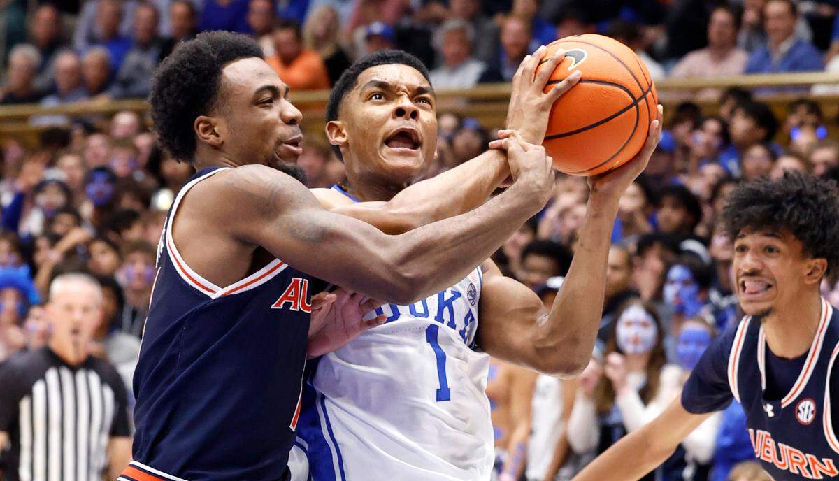 Duke’s Caleb Foster (1) drives by Auburn’s JP Pegues (1) during the first half of Duke’s game against Auburn at Cameron Indoor Stadium in Durham, N.C., Wednesday, Dec. 4, 2024.