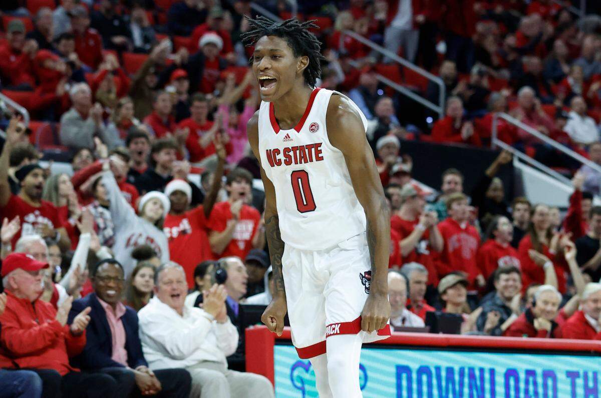 N.C. State’s Terquavion Smith (0) celebrates hitting a three-pointer during the second half of N.C. State’s 76-64 victory over Louisville at PNC Arena in Raleigh, N.C., Thursday, Dec. 22, 2022.