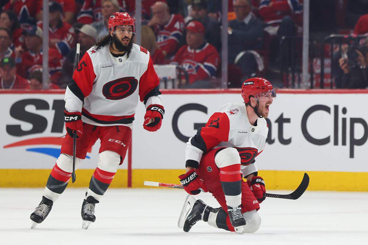 Andrei Svechnikov (37) of the Carolina Hurricanes celebrates in front of teammate Janlen Chatfield after scoring the game-winning goal against the Montréal Canadiens during overtime in Game 3 of the Eastern Conference Final of the 2026 Stanley Cup Playoffs at Bell Centre on May 25, 2026 in Montreal, Quebec, Canada.