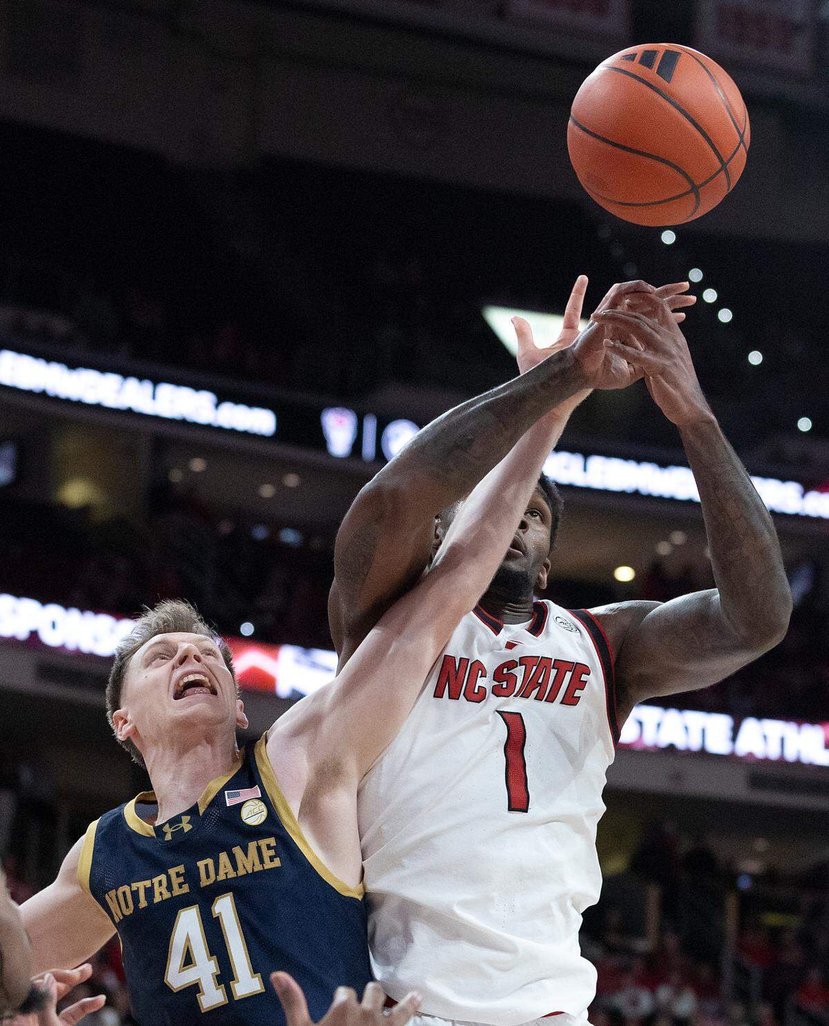 Notre Dame’s Matt Allocco and N.C. State’s Brandon Huntley-Hatfield battle for a rebound during the first half of the Wolfpack’s game on Wednesday, Jan. 8, 2025, at Lenovo Center in Raleigh, N.C.