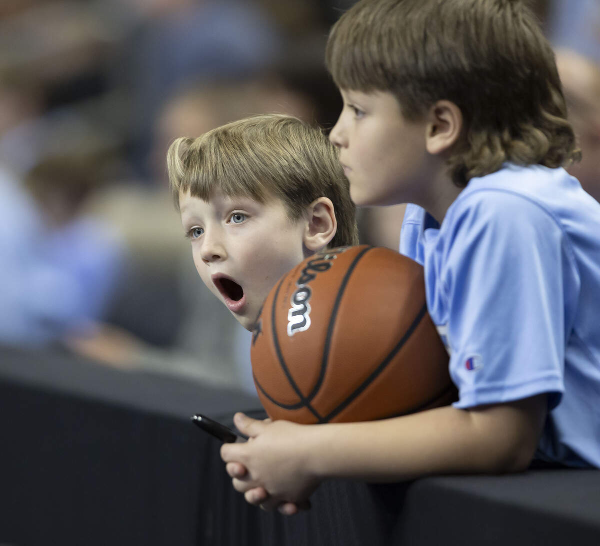 Six-year-old Dillon Driver of Anderson, S.C. spots his favorite player, North Carolina forward Caleb Wilson, as he watches the Tar Heels’ practice with his brother older Lucas Driver on Wednesday, March 18, 2026, at Bon Secours Arena in Greenville, S.C.