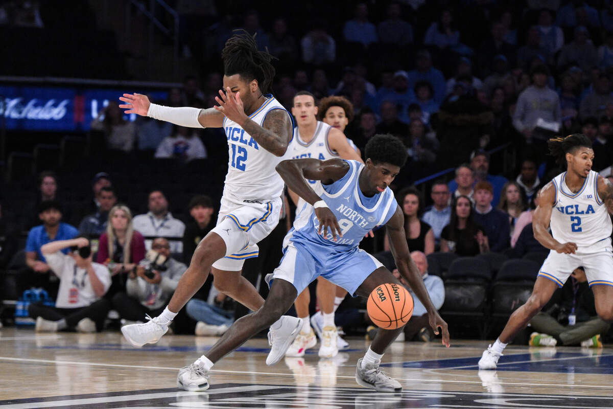 North Carolina Tar Heels guard Drake Powell (9) tries to gain control of the ball as UCLA Bruins guard Sebastian Mack (12) defends during the first half at Madison Square Garden.