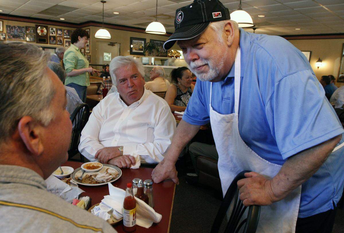 L to R: Ben Boyett of Kernersville, N.C., and longtime customer Walter Lasley, also of Kernersville, talk with Bullock's Barbecue owner Tom Bullock. The men came from out of town to support Bullock and his restaurant.