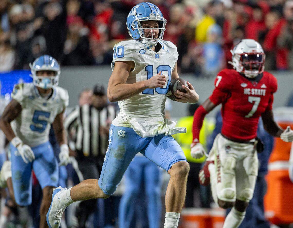North Carolina quarterback Drake Maye (10) breaks open on a 56-yard gain in the third quarter against N.C. State on Saturday, November 25, 2023 at Carter-Finley Stadium in Raleigh, N.C.