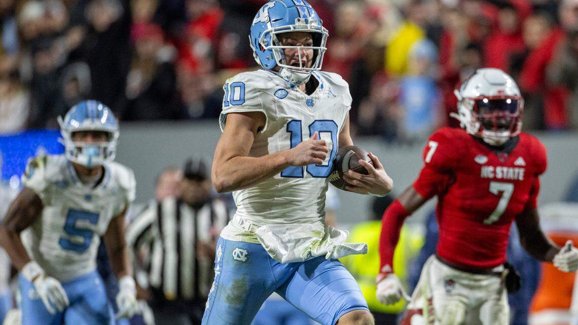 North Carolina quarterback Drake Maye (10) breaks open on a 56-yard gain in the third quarter against N.C. State on Saturday, November 25, 2023 at Carter-Finley Stadium in Raleigh, N.C.