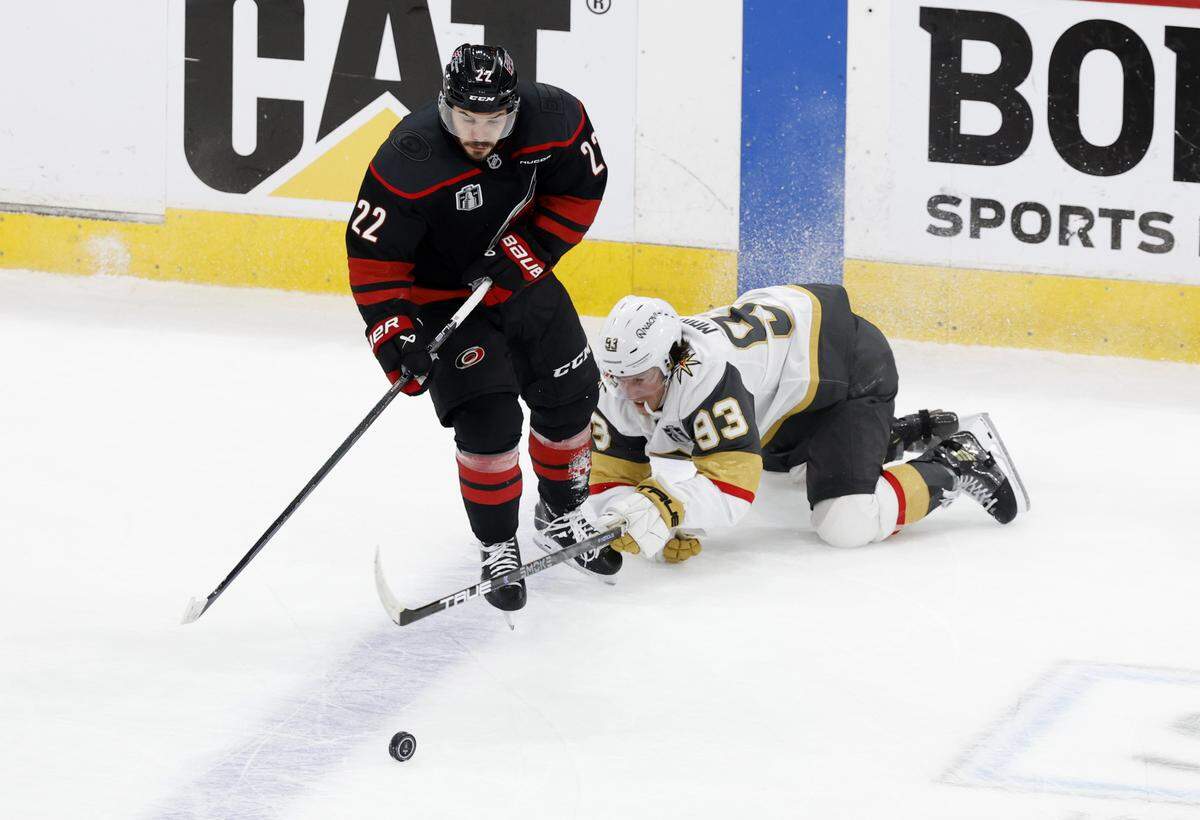 Carolina's Logan Stankoven (22) brings the puck past Vegas’ Mitch Marner (93) in the second period of the Hurricanes’ game against the Golden Knights in the second game of the Stanley Cup Final at the Lenovo Center in Raleigh, N.C., Thursday, June 4, 2026.