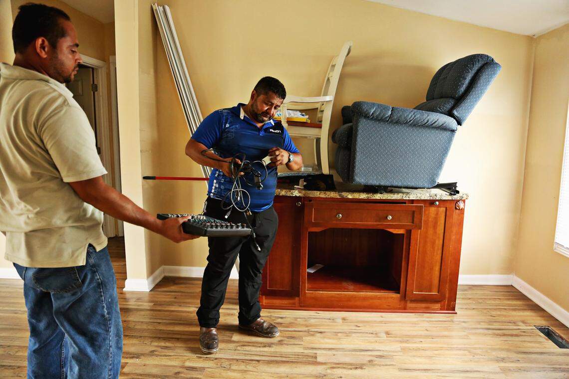 Roommates from left, Yobany Castillo and Numan Herrera clear out the last items from Herrera’s mobile home on Sunday, Sept. 16, 2018, located in the Edwards Mobile Park that flooded during Hurricane Matthew. Castillo and Herrera had spent most of the evening moving the majority of the furniture to a storage unit and was planning on locking the home up. It took a year for Herrera to repair the home after severe flooding from Hurricane Matthew.