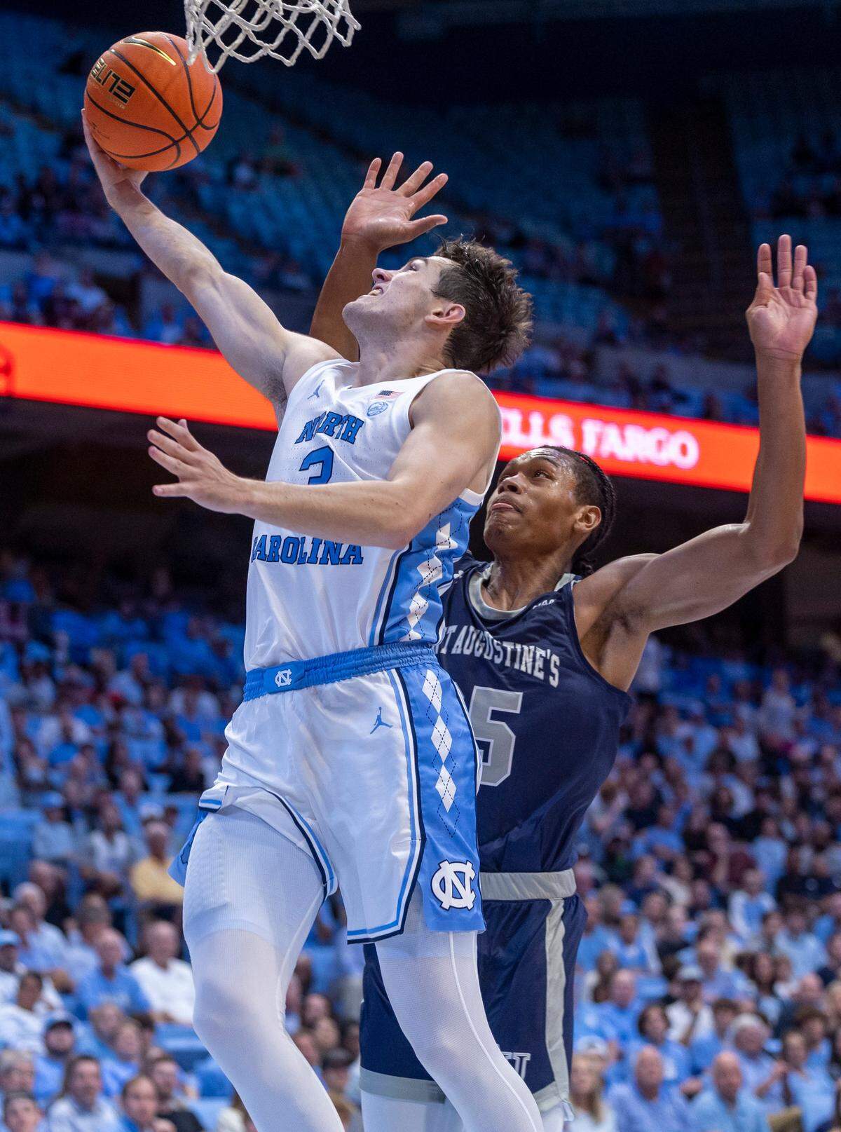 North Carolina’s Cormac Ryan (3) breaks to the basket in the first half against St. Augustine’s Mac Hughes (25) on Friday, October 27, 2023 at the Smith Center in Chapel Hill, N.C.