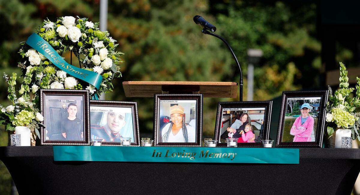 A memorial was set up on the stage for a candlelight vigil Saturday, Oct.15, 2022, for those killed and wounded in a mass shooting in the Hedingham neighborhood in Raleigh, N.C., on Thursday.