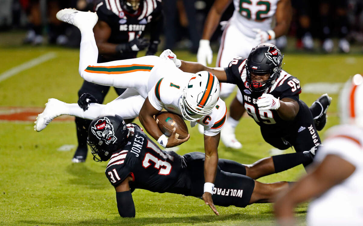 N.C. State linebacker Vi Jones (31) sacks Miami quarterback D’Eriq King (1) during the first half of N.C. State’s game against Miami at Carter-Finley Stadium in Raleigh, N.C., Friday, Nov. 6, 2020.