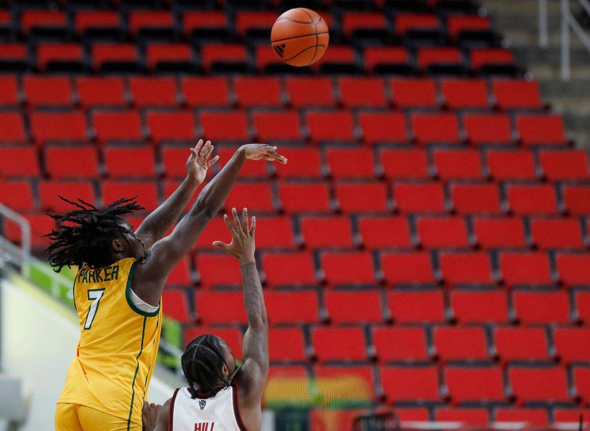 Lees-McRae’s Anthony Parker shoots over N.C. State’s Marcus Hill, Jr. during the second half of the Wolfpack’s 79-75 exhibition win on Wednesday, Oct. 30, 2024, at the Lenovo Center.