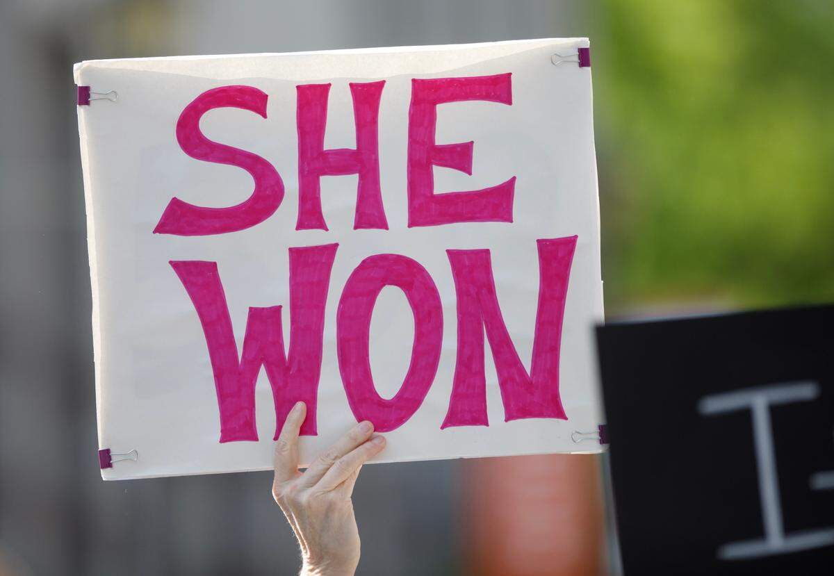 People hold signs during a rally on Monday, April 14, 2025, in Raleigh, N.C., held in protest of Republican state Supreme Court candidate Jefferson Griffin’s challenge of 65,000 votes in the November election.