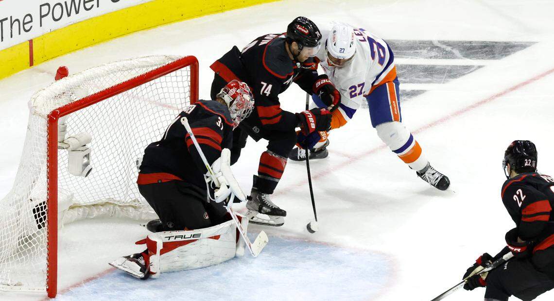 Carolina goaltender Frederik Andersen (31) makes the save as New York left wing Anders Lee (27) shoots during the second period of the Hurricanes game against the Islanders in the first round of the Stanley Cup playoffs at PNC Arena in Raleigh, N.C., Saturday, April 20, 2024. Carolina defenseman Jaccob Slavin (74) defends Lee.