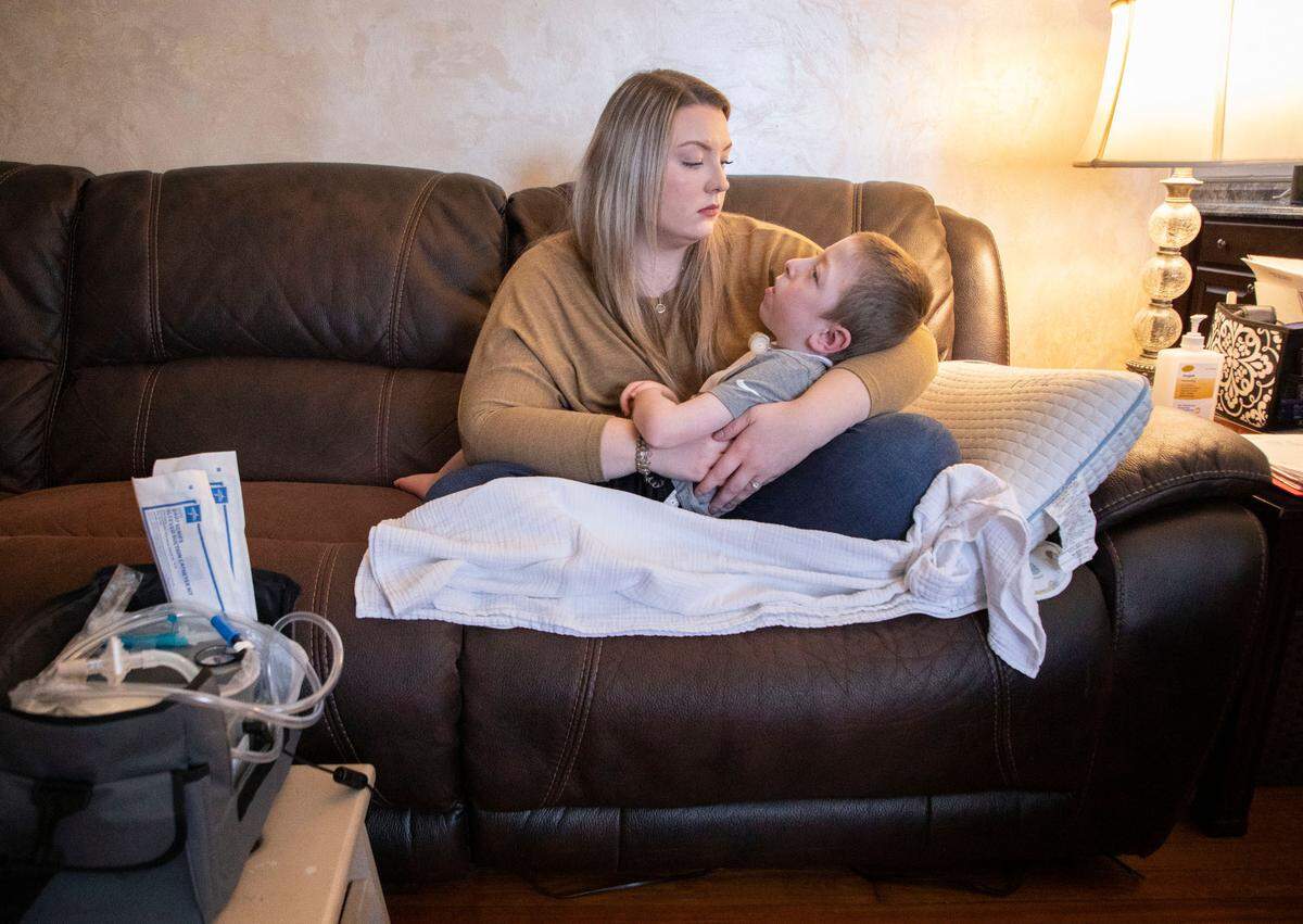 Claudia Moore holds her son Boston Yannotti, 5, who has an ultra-rare disease called AADC deficiency, in their living room in Eden, N.C. on March 9, 2022.