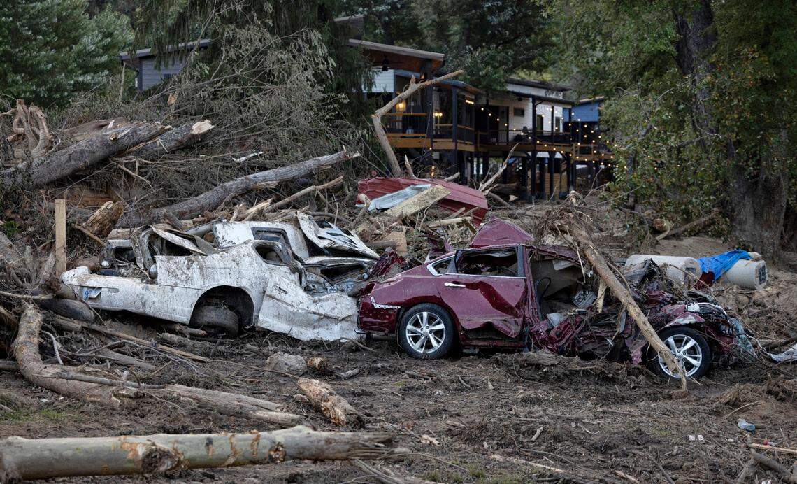 Two cars, completely demolished by flood waters from Mills Creek in the aftermath of Hurricane Helene on Wednesday, October 2, 2024 in Old Fort, N.C.