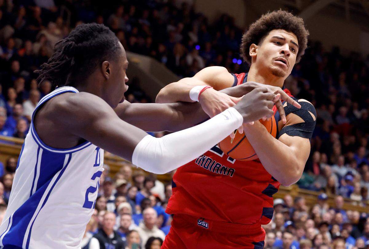 Southern Indiana’s A.J. Smith (21) pulls in the rebound from Duke’s Mark Mitchell (25) during the second half of Duke’s 80-62 victory over Southern Indiana at Cameron Indoor Stadium in Durham, N.C., Friday, Nov. 24, 2023.