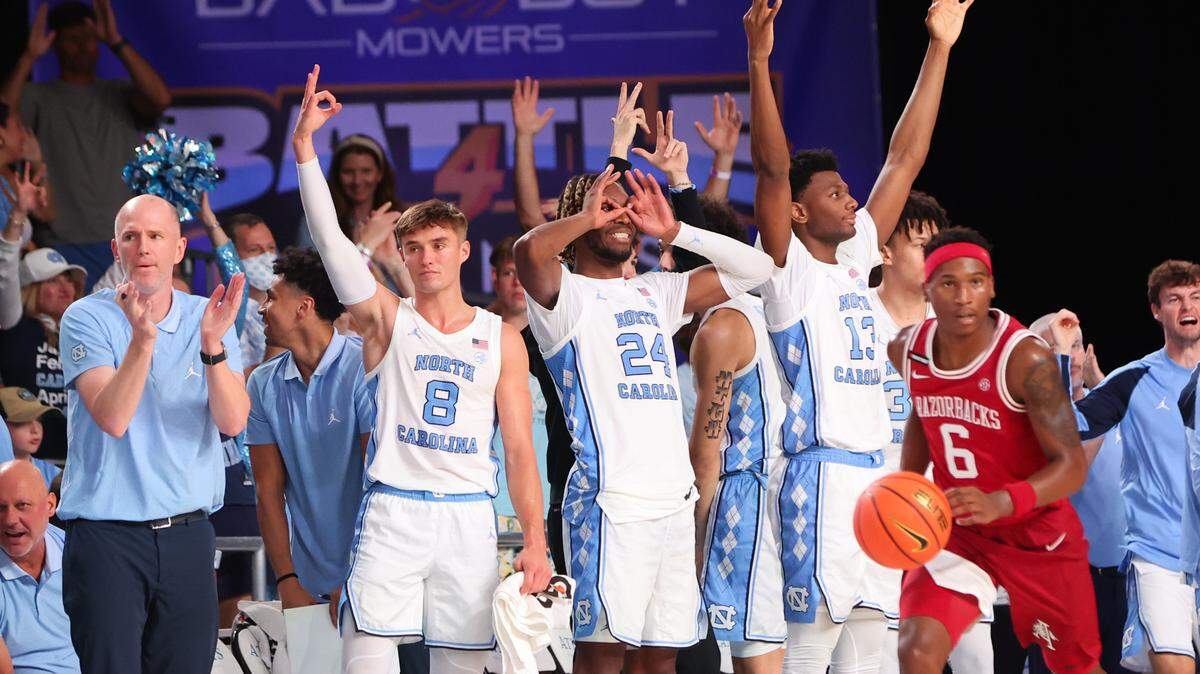 North Carolina Tar Heels guard Paxson Wojcik (8) and North Carolina Tar Heels forward Jae’Lyn Withers (24) and North Carolina Tar Heels forward Jalen Washington (13) react during the second half against the Arkansas Razorbacks at Imperial Arena.