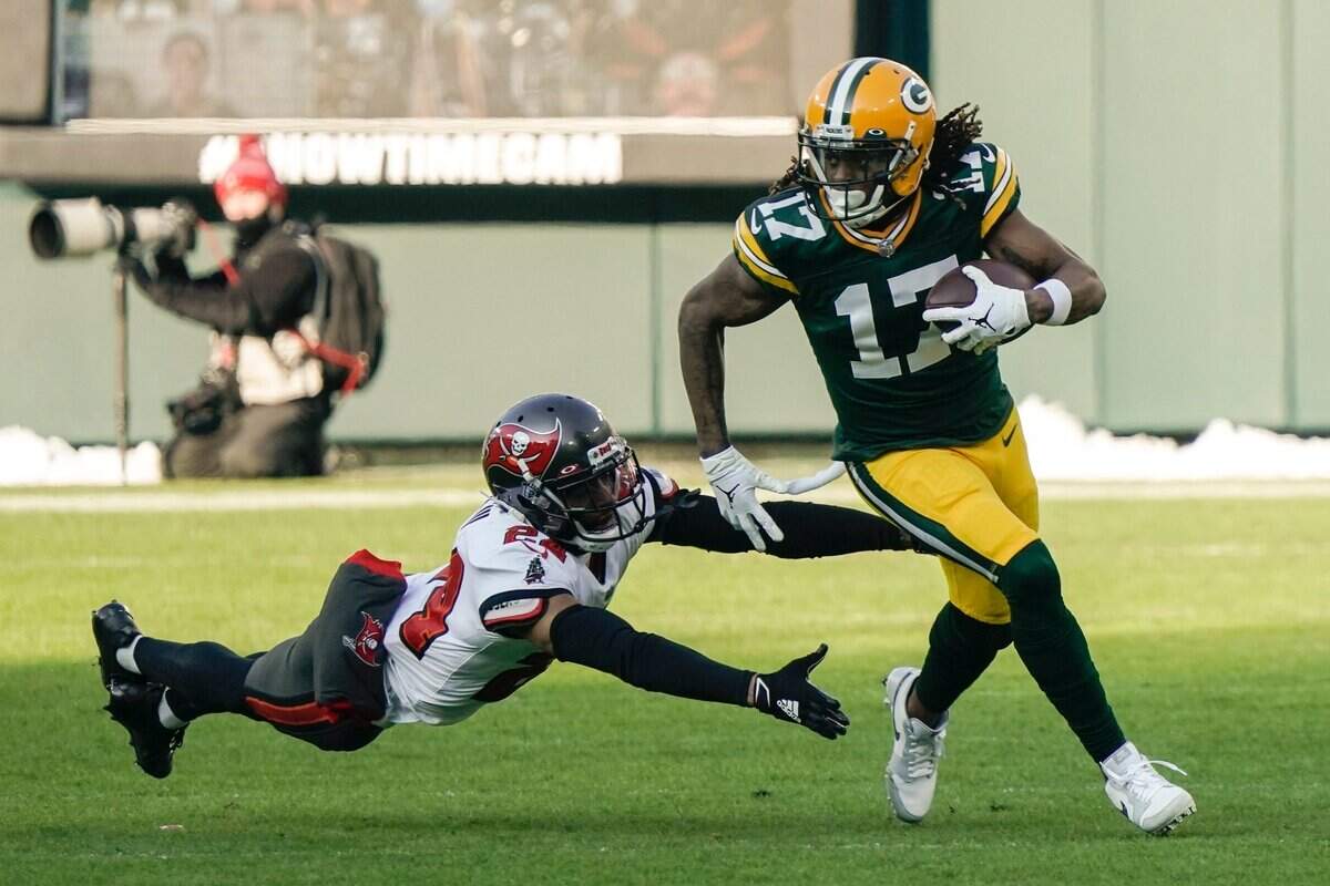 Tampa Bay Buccaneers’ Carlton Davis dives in an attempt to stop Green Bay Packers’ Davante Adams during the first half of the NFC championship NFL football game in Green Bay, Wis., Sunday, Jan. 24, 2021.