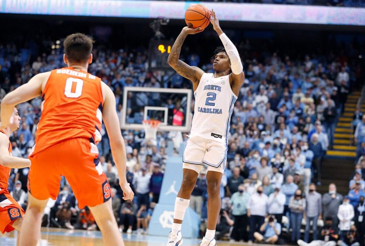 With the Tar Heels trailing 71-70, North Carolina’s Caleb Love (2) makes the three-point shot with eight seconds left in regulation during UNCs 88-79 overtime victory over Syracuse at the Smith Center in Chapel Hill, N.C., Monday, Feb. 28, 2022.