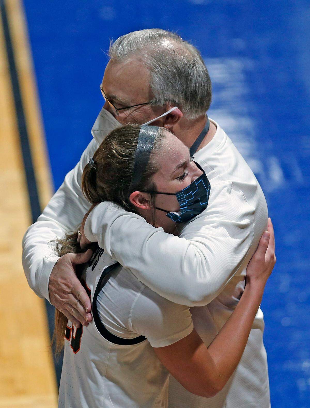 Oklahoma State head coach Jim Littell hugs Oklahoma State guard Lexy Keys(15) at the end of the game of a college basketball game in the first round of the women’s NCAA tournament at the Greehey Arena in San Antonio, Texas, Sunday, March 21, 2021.