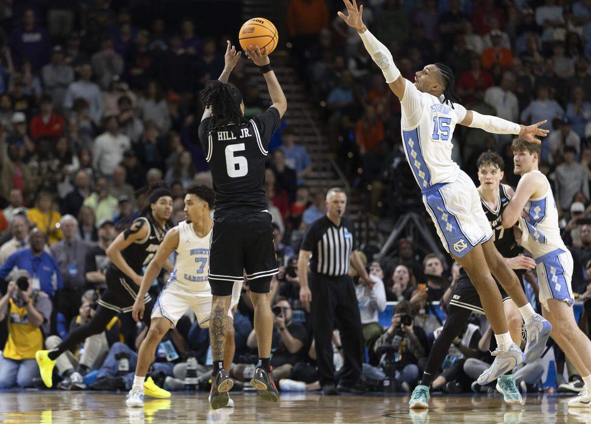 VCU guard Terrence Hill Jr. (6) launches a three-point shot in with :15 seconds to play in overtime to to take an 80-78 lead over North Carolina on Thursday, March 18, 2026, during the first round of the NCAA Tournament at Bon Secours Arena in Greenville, S.C. Hill scored 34 points in their 82-78 victory. 
